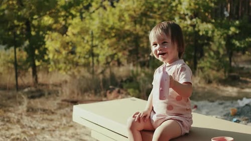 Smiling Child Playing with Toy Outdoors on Sunny Day