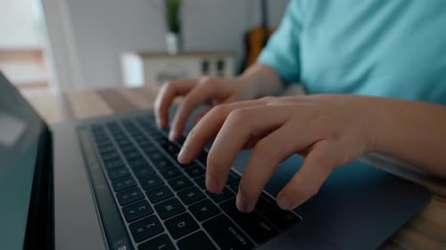 Fingers of Woman Typing on Keyboard of Modern Laptop