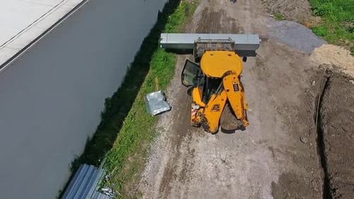Baumaschinen bei der Arbeit. Luftbild des Traktors während der Arbeit auf der Baustelle