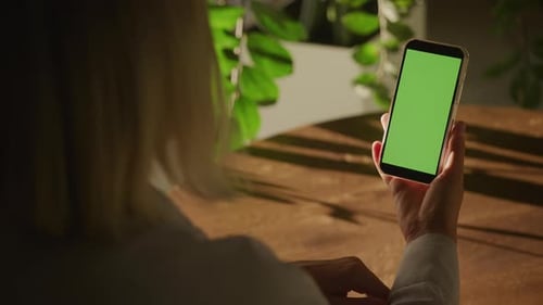 Woman Swiping on Smartphone with Green Screen
