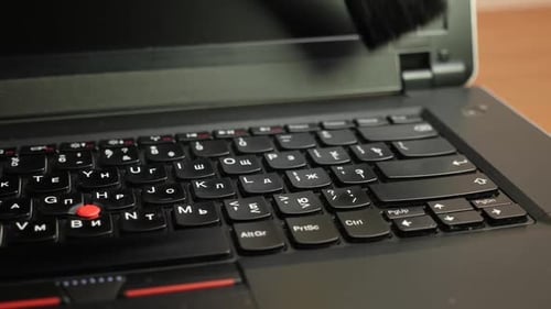 Laptop Keyboard Cleaning with a Brush Close Up