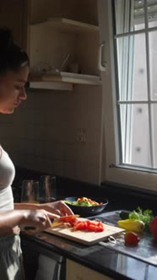 Woman Prepares Healthy Salad in Sunny Kitchen