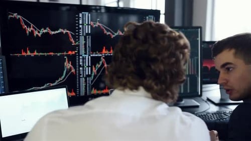 Team of stockbrokers works together in modern office at daytime