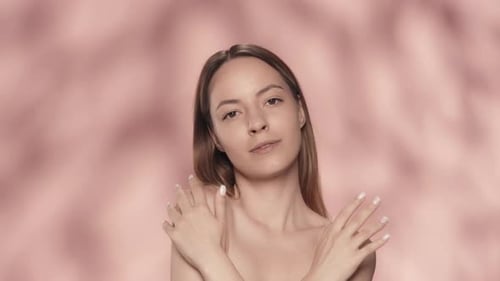 A Woman Crosses Her Arms and Runs Over the Smooth Soft Skin of Her Hands and Shoulders A Seminude