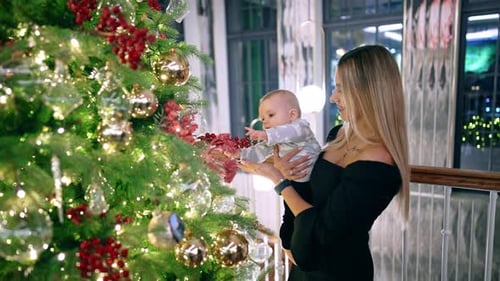 Loving Family by Christmas Tree with Baby