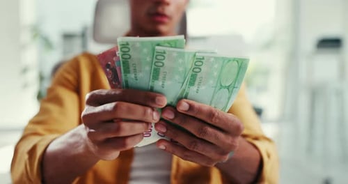 Man, hands and counting cash in office for business, finance management or budget control