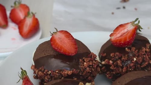 A Woman Garnishes A Brownie Sandwich With Mascarpone Cream With Strawberry Slices. Close Up.