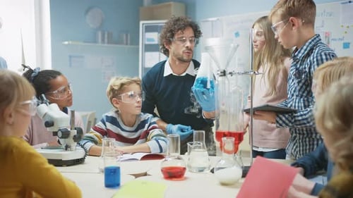 Elementary School Science Classroom: Enthusiastic Teacher Explains Chemistry to Diverse Group of Ch