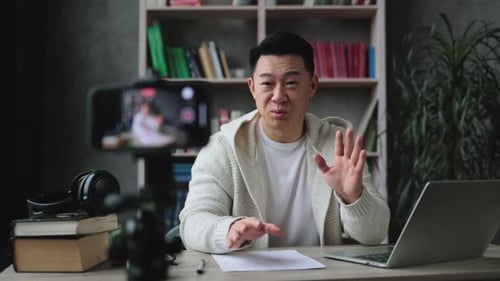 Man Recording Himself Talking at His Desk