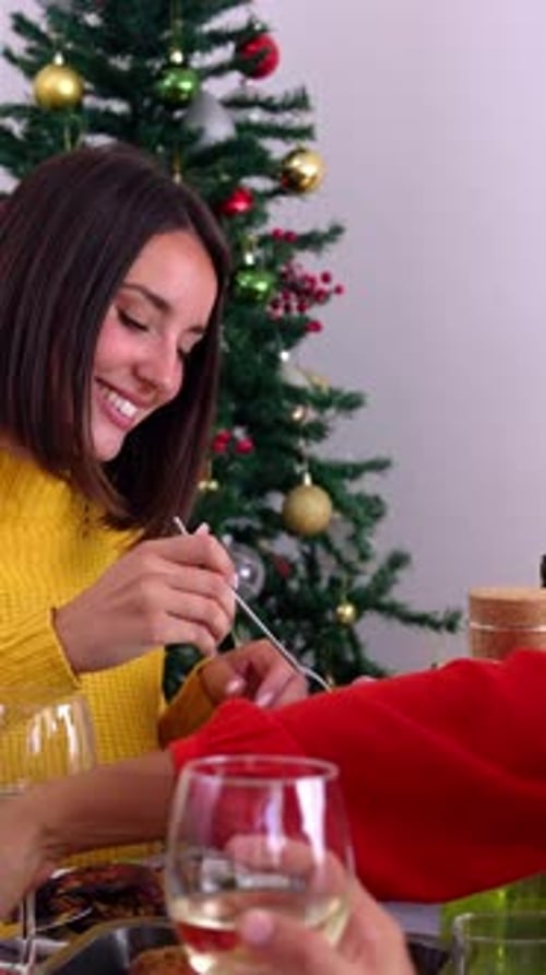 Woman enjoying salad at Christmas dinner with family