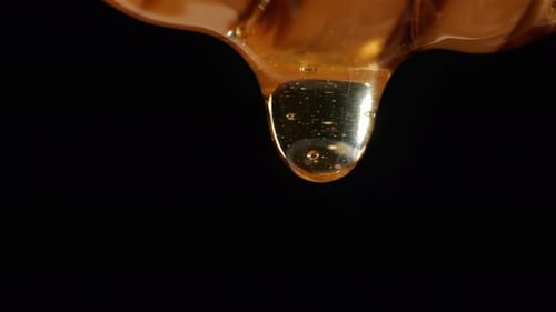 Honey Drips On A Black Background. Healthy Organic Thick Honey, Sweet Dessert