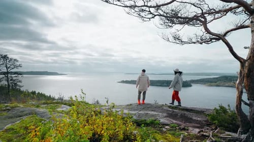 Pair Of Travelers Climbing At Top Of Mount With Beautiful View On Big Lake Tourism And Traveling
