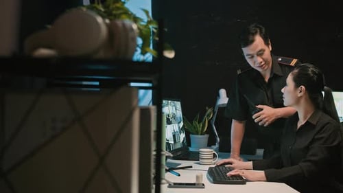 Team Monitors Security Camera Feeds in Bright Office