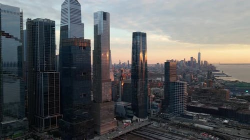 Aerial view of Midtown skyscrapers, the river and the New Jersey skyline, sunset in NYC - pan, drone