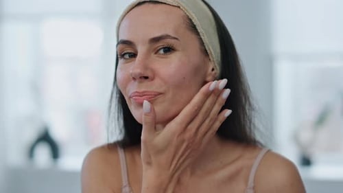 Young Woman Washing Her Face In Bathroom