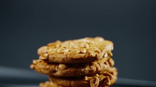 Close Up on Black and Blue Background Flat Plate with Cookie Cookies Built in a Pyramid Sweet