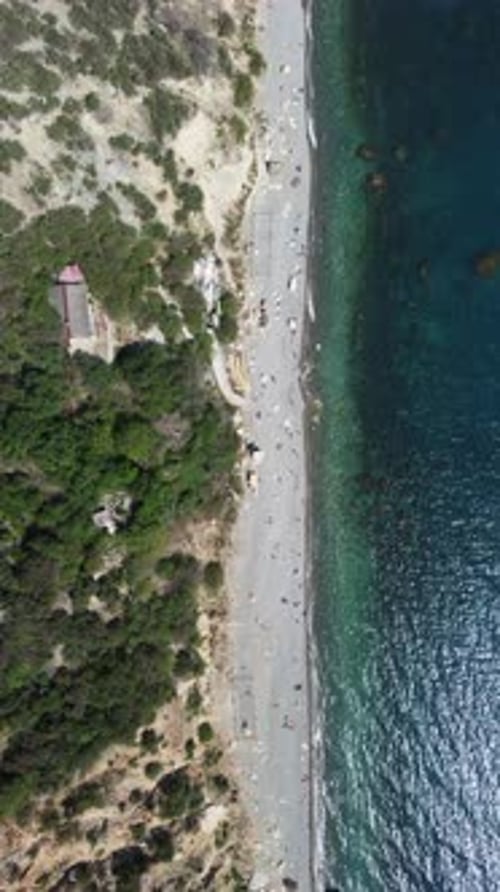 Aerial Top Down on Summer Beach Swimming People in Sea Bay with Transparent Blue Water and Volcanic