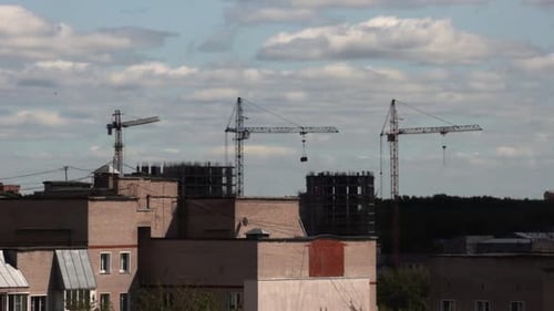 Construction Cranes dominate the Skyline in Urban Area