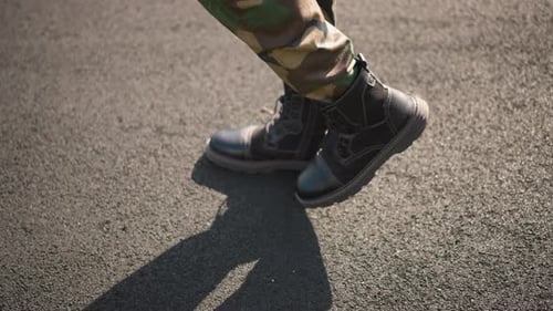 Walking in Camo Pants and Black Work Boots