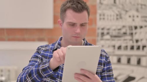 Young Adult Using a Tablet Indoors
