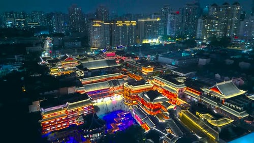 Aerial View of the Illuminated Traditional Yu Garden Architecture Surrounded By Modern Highrise