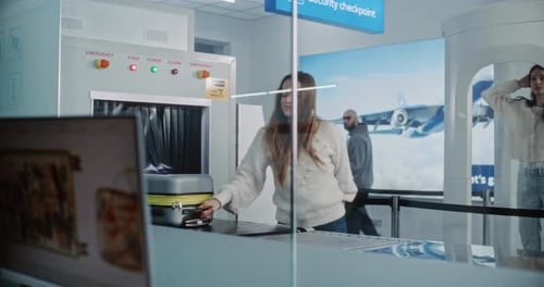 Diverse Passengers Taking Luggage After Screening Monitor Displaying Software for Scanning Baggage