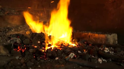 Bright Flames Burning in Coal Forge at Night