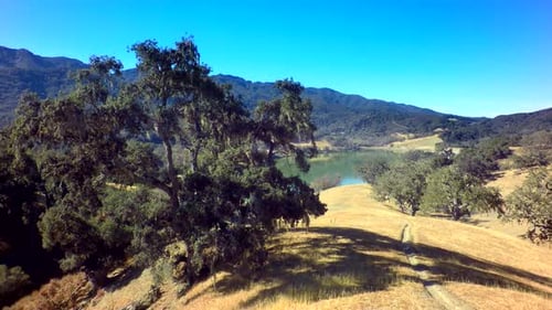Aerial View Of Gorgeous Mountainside Lake On Sunny Day 5