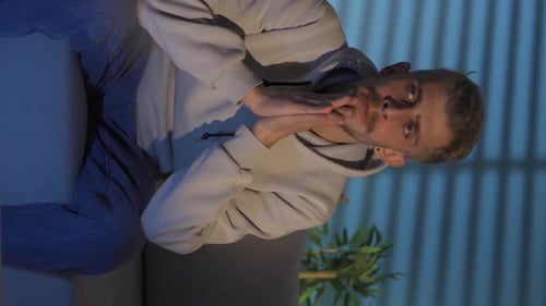 Distressed Young Adult on Couch at Night