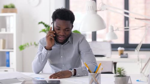 Professional Man Talking on Phone in Modern Office