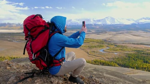 Caucasian Backpacker with Rucksack Use Telephone Online Holding Device Taking Photo with Smart Phone