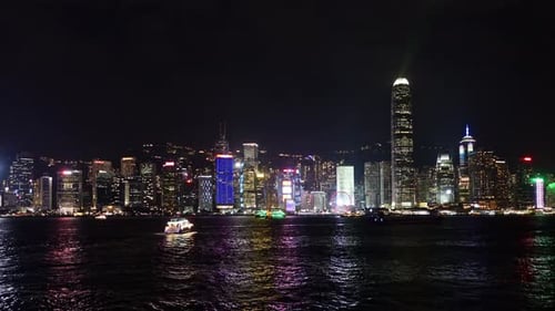 Nighttime Aerial View of Hong Kong Skyline with Illuminated Skyscrapers and Harbor