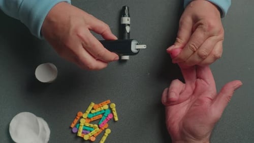 Person Checks Blood Glucose Level with Glucometer
