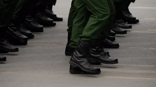Soldiers Marching in Black Boots and Green Uniforms