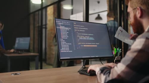 Programmer Is Writing Code And Developing New Software In Office Of ITCompany Display Of Computer