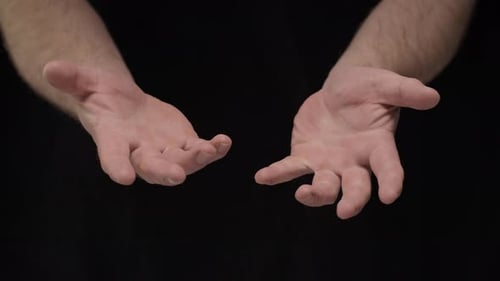 Open Hands Against Black Background