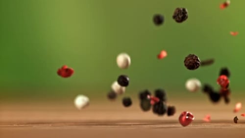 Mixed Peppercorns Falling in Slow Motion
