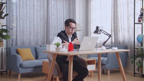 Sick Asian Businessman Cold While Working With Laptop In The Living Room At Home