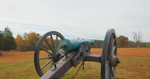 Cannon on Battlefield in Rural Setting on Overcast Day