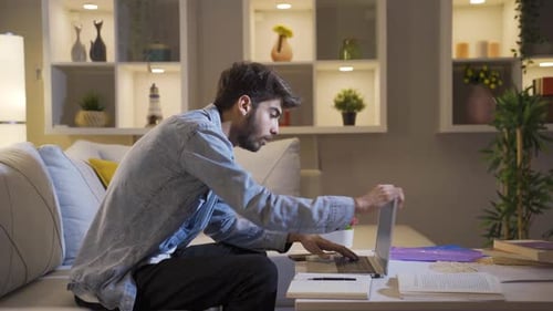 Young Adult Working on Laptop at Home