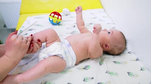 Infant Receiving Leg Massage on Changing Table
