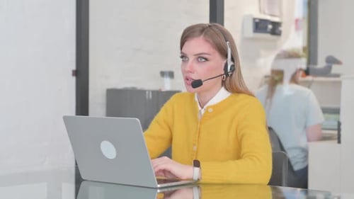 Woman with Headset Talking with Customer in Call Center
