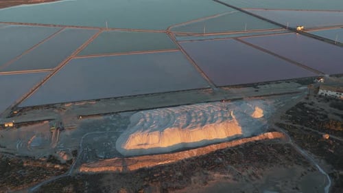 Aerial view of salt pans and salt mountain at sunset