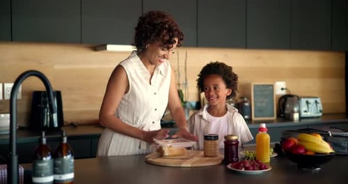 Child, mother and packing school lunch in home for morning routine, healthy nutrition