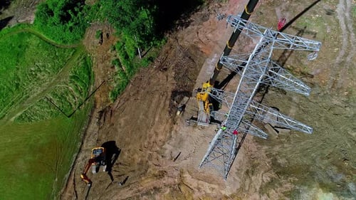 Building high voltage electricity tower. Heavy duty machinery.