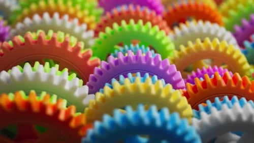 Looping 3D animation multi-colored plastic toy gears.