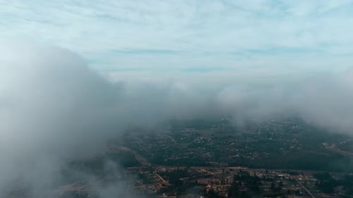 Aerial view dolly in of a flight through the clouds passing through