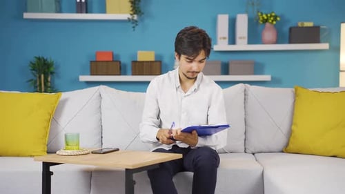 Young Adult Fills Out Forms on Clipboard