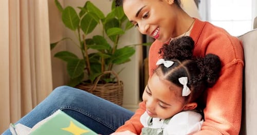 Woman and Child Read a Book on the Couch