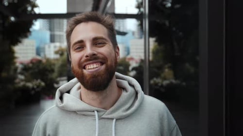 Smiling Bearded Man in Urban Setting Close Up